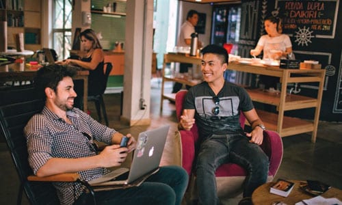 Two men talking at coffee bar