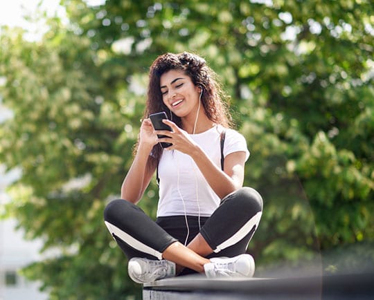 Girl listening to podcast from phone