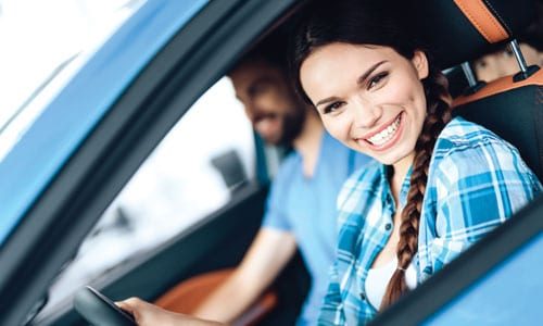 Young woman driving car